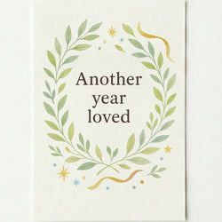 'Another year loved' card on a plain white background.