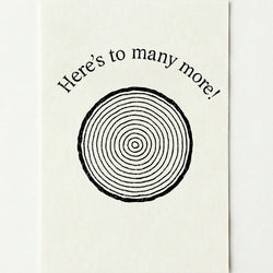 'Here's to many more!' card on a plain white background.